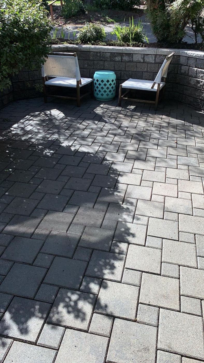 Clean paver patio with two chairs